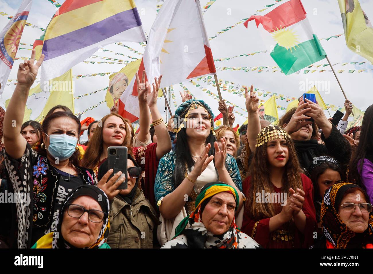 Syrian Kurdish women, most of them wearing traditional clothing, gather ...