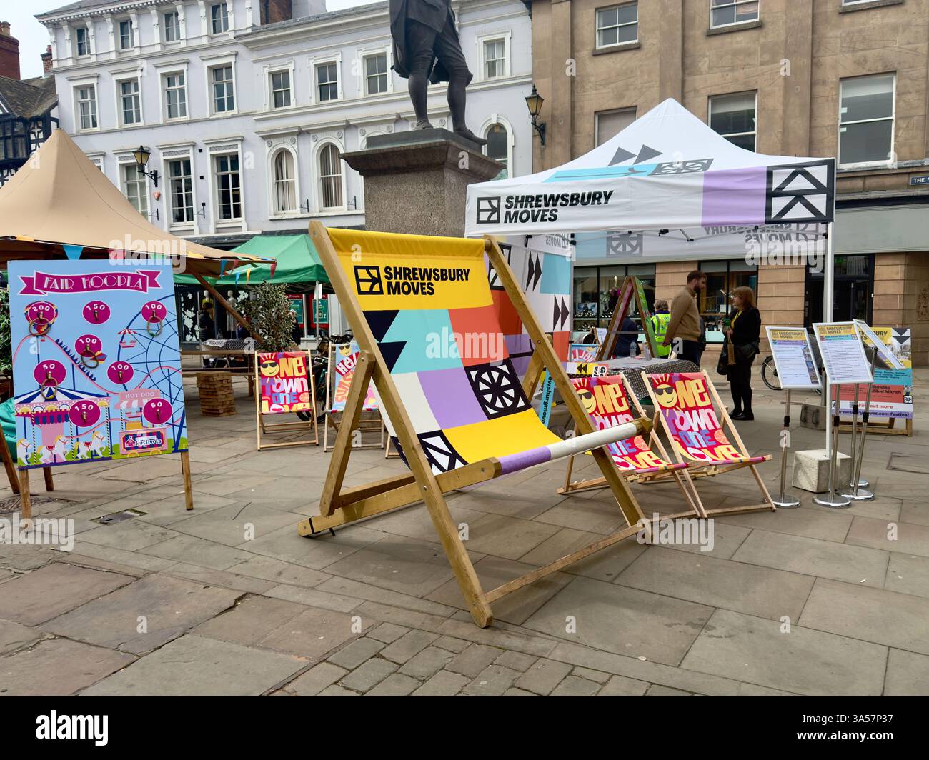 Brightly coloured deckchairs and other display items in The Square in Shrewsbury to promote the Shrewsbury Moves Festival. - Smartphone Captured Stock Image
