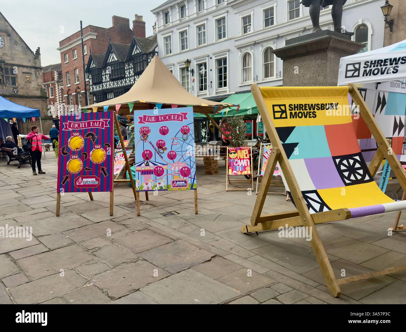 Brightly coloured deckchairs and other display items in The Square in Shrewsbury to promote the Shrewsbury Moves Festival. - Smartphone Captured Stock Image