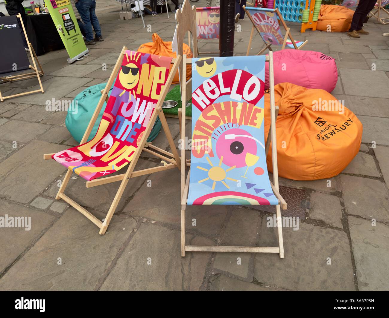 Brightly coloured deckchairs and other display items in The Square in Shrewsbury to promote the Shrewsbury Moves Festival. - Smartphone Captured Stock Image