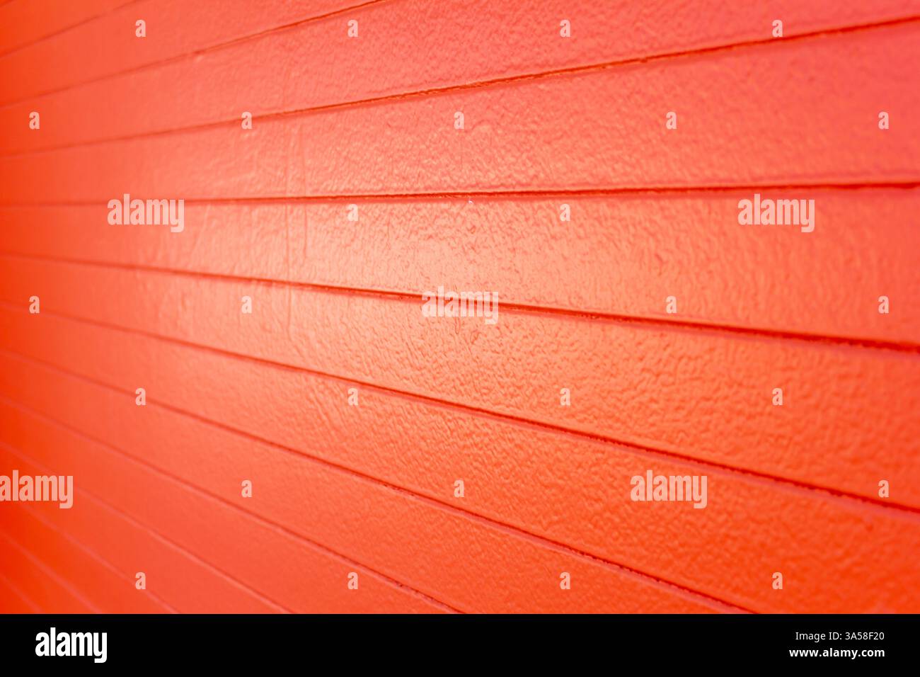 A view of an orange painted concrete wall, as a background. Stock Photo