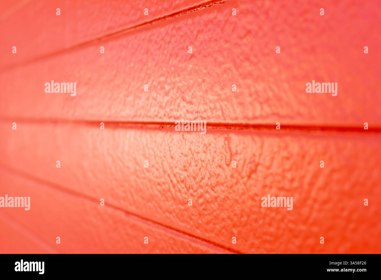 A view of an orange painted concrete wall, as a background. Stock Photo
