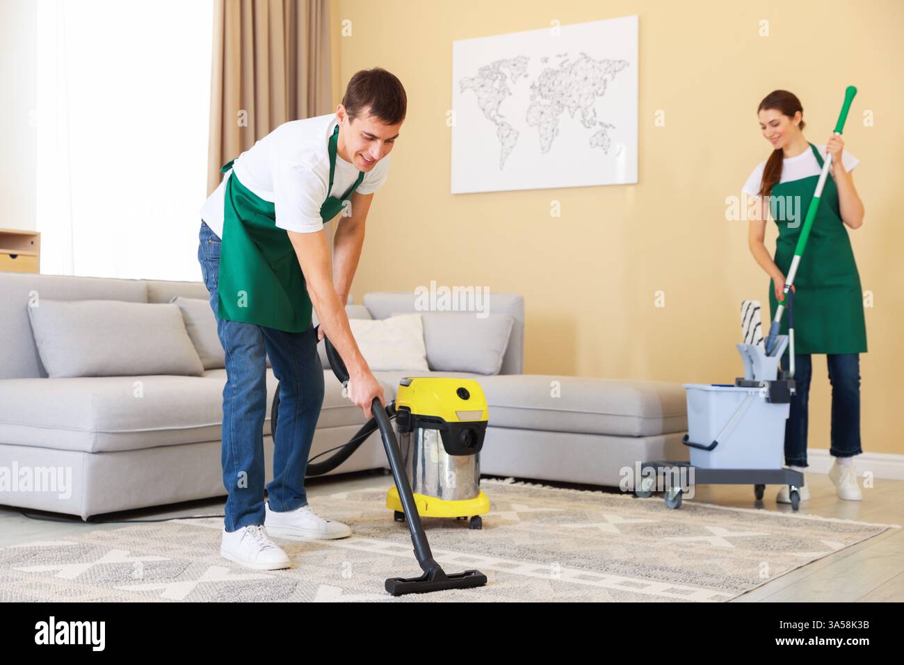 Professional cleaning service team working in room Stock Photo - Alamy