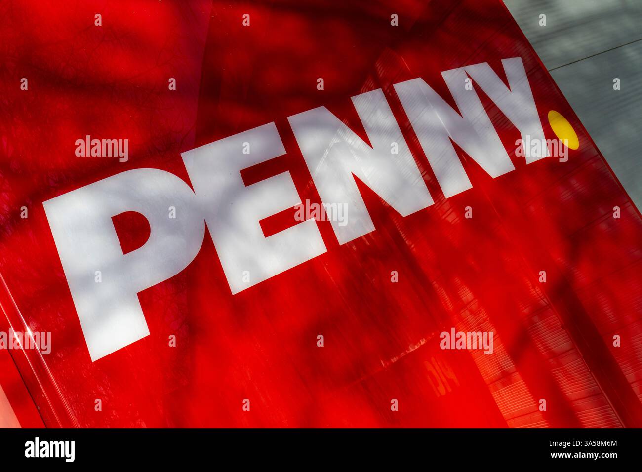 Bright red signage prominently displays the word Penny. The lettering ...