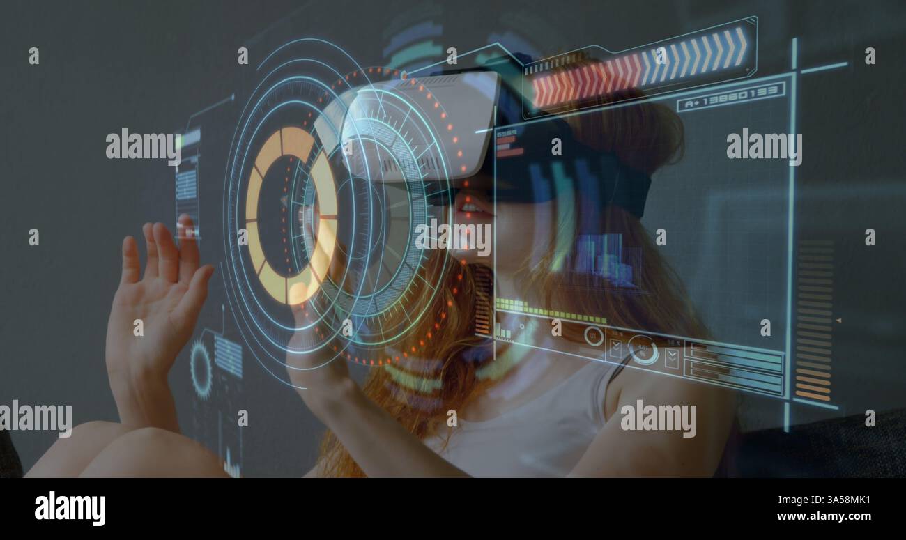 Woman using VR headset interacting with digital interface, exploring virtual reality Stock Photo