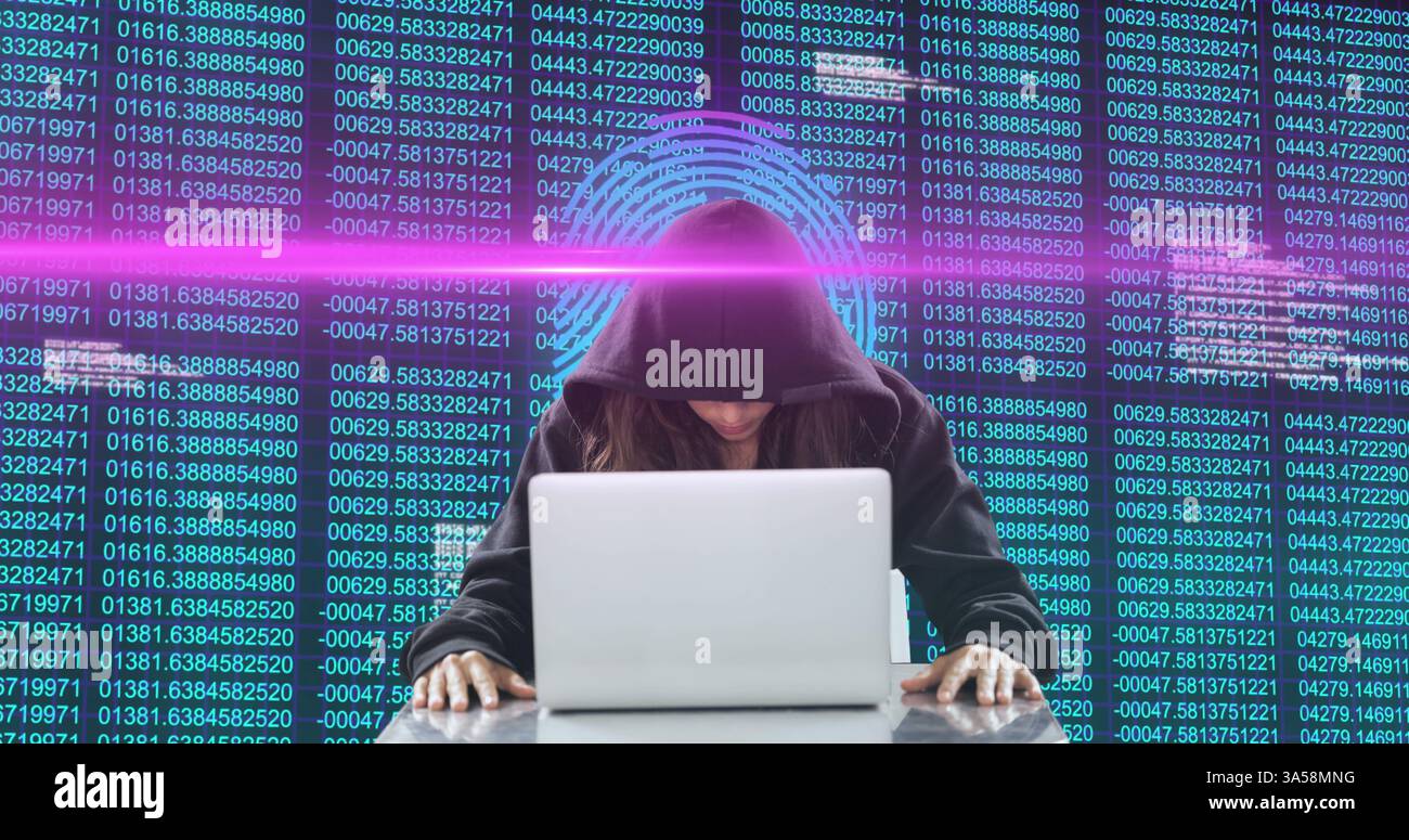 Hacker in hoodie using laptop with digital code and glowing interface Stock Photo