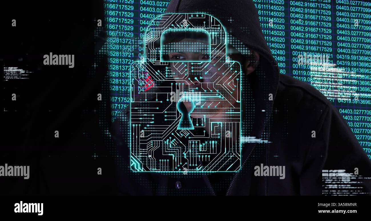 Hacker in hoodie surrounded by digital lock and binary code, focused on screen Stock Photo