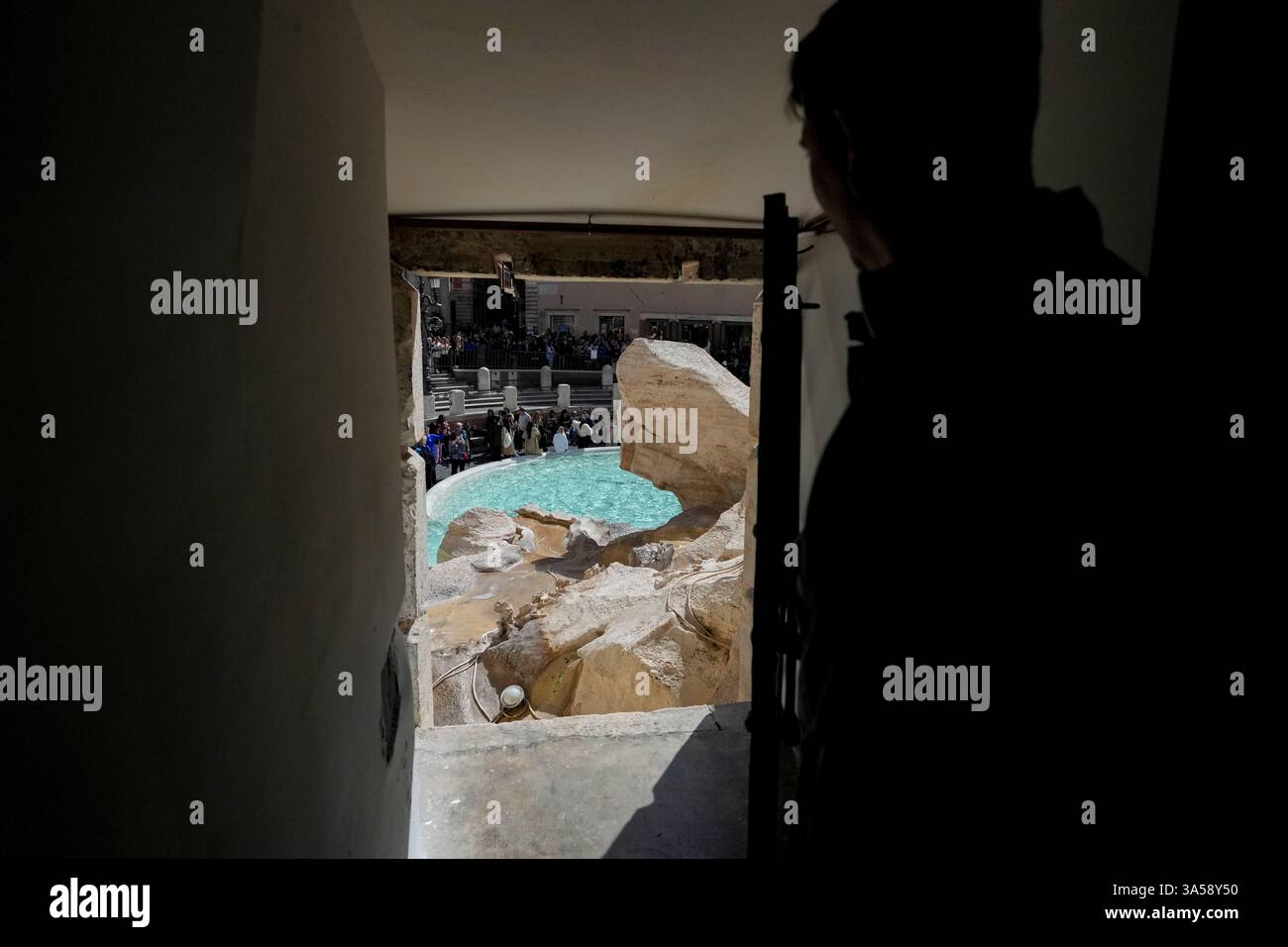A worker of Rome's main water and energy company, ACEA, opens a window ...