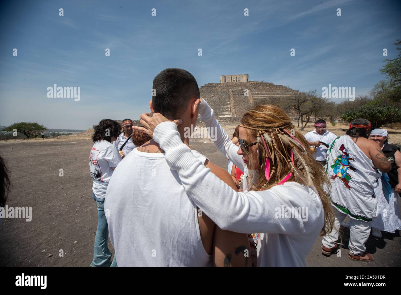 People rise their hands during a ritual to recharge themselves with ...