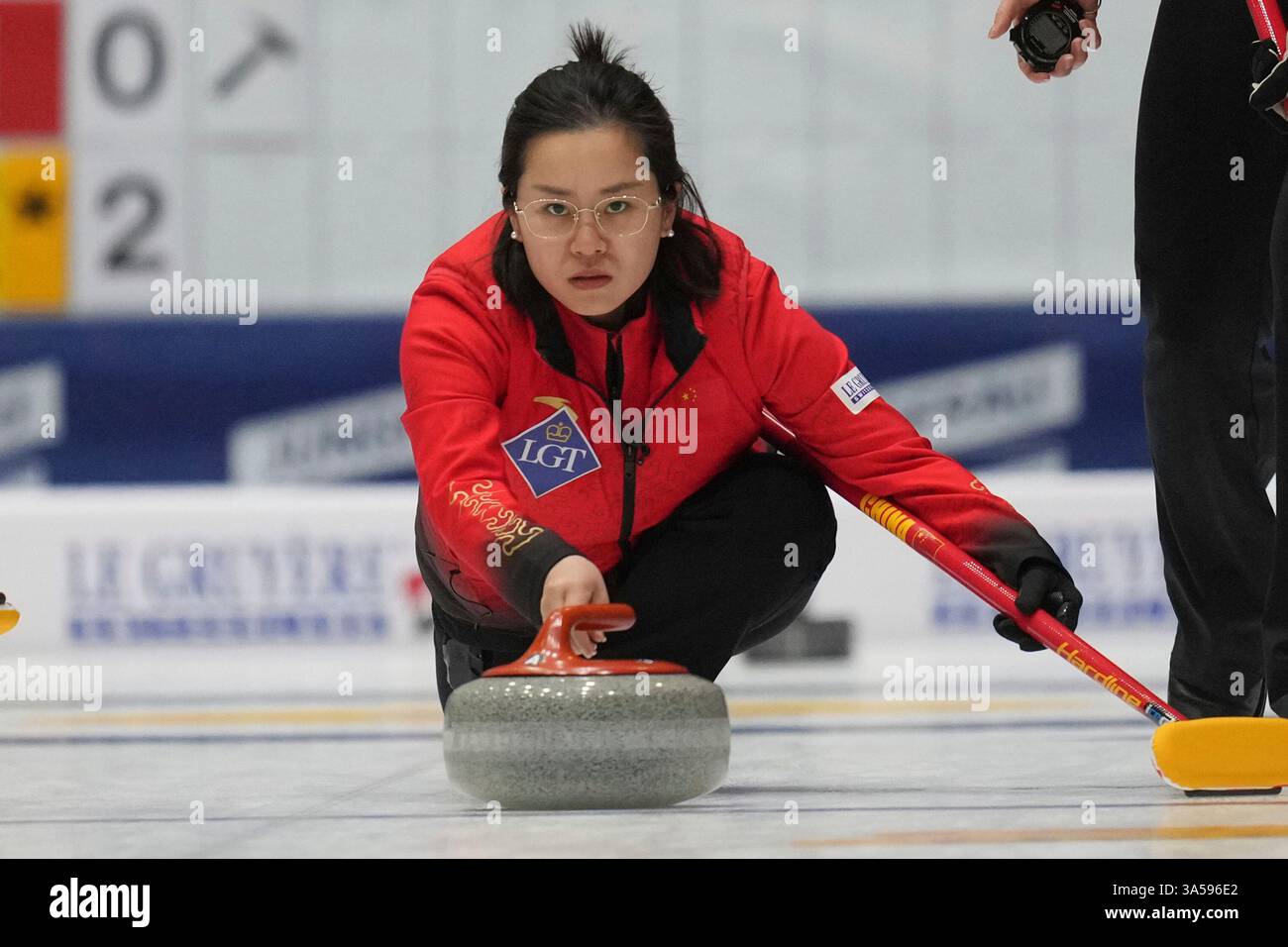 China's skip Wang Rui releases the stone during the qualification match ...