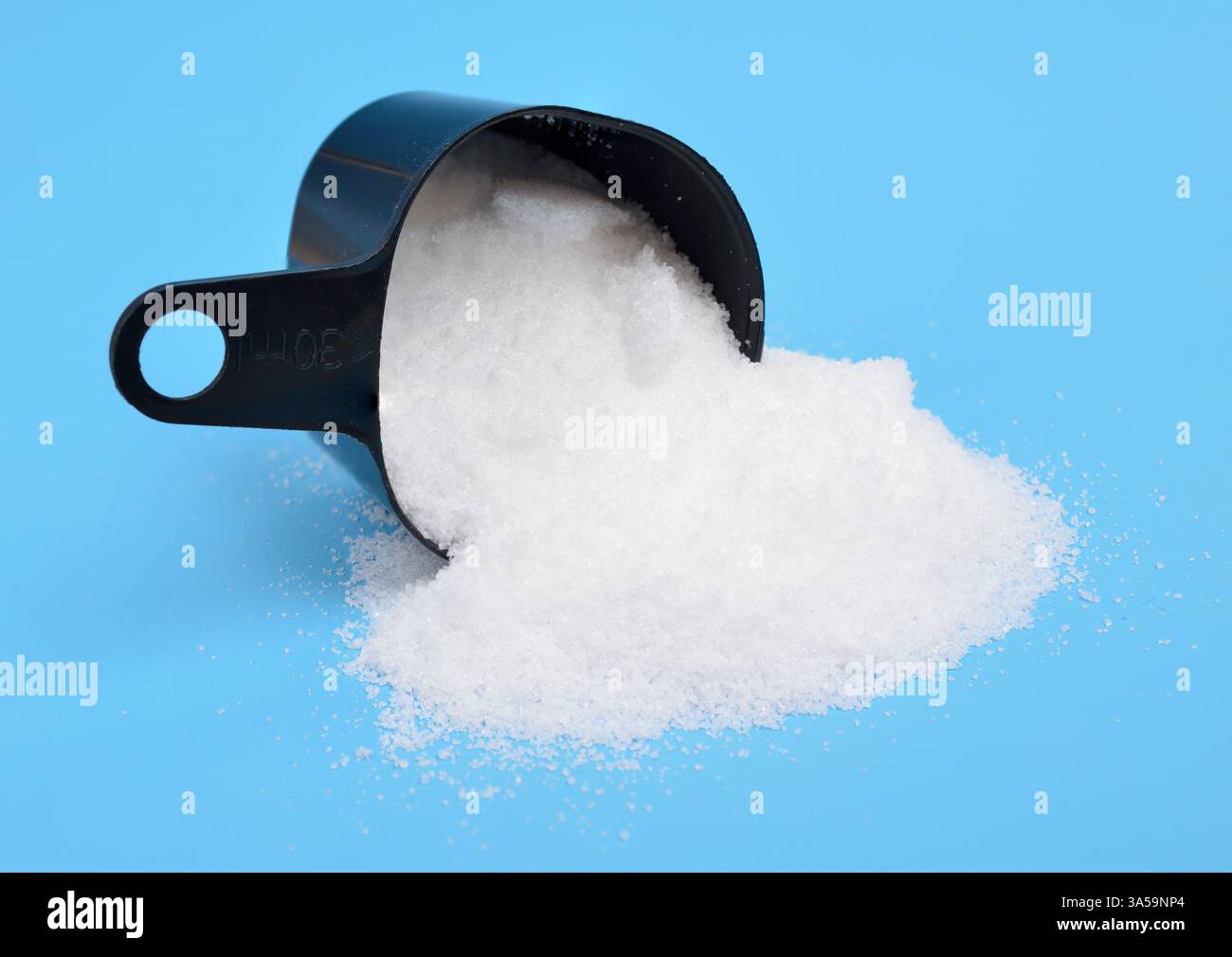 Thiourea powder on blue background Stock Photo