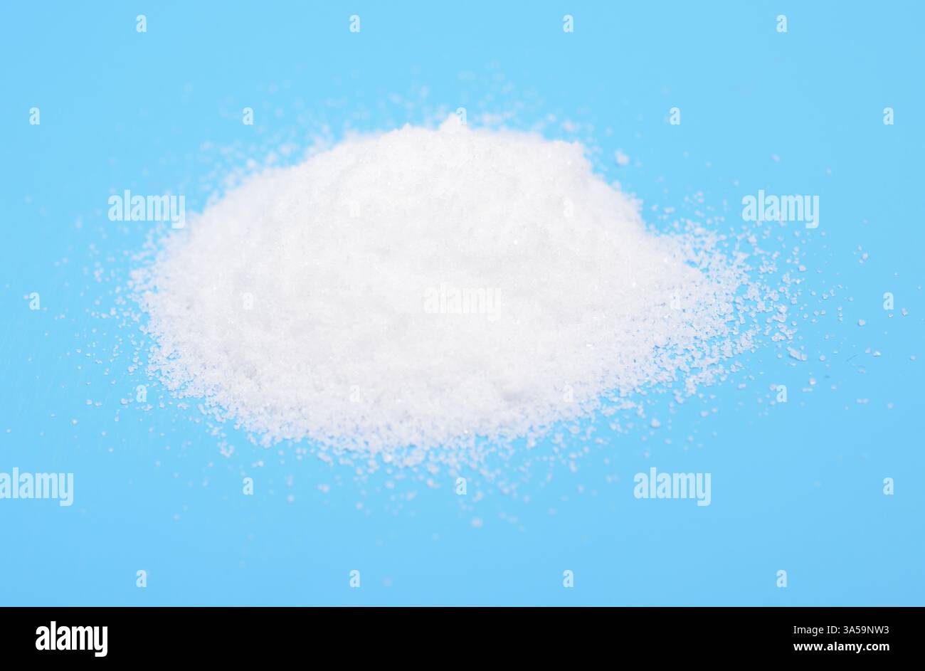 Thiourea powder on blue background Stock Photo