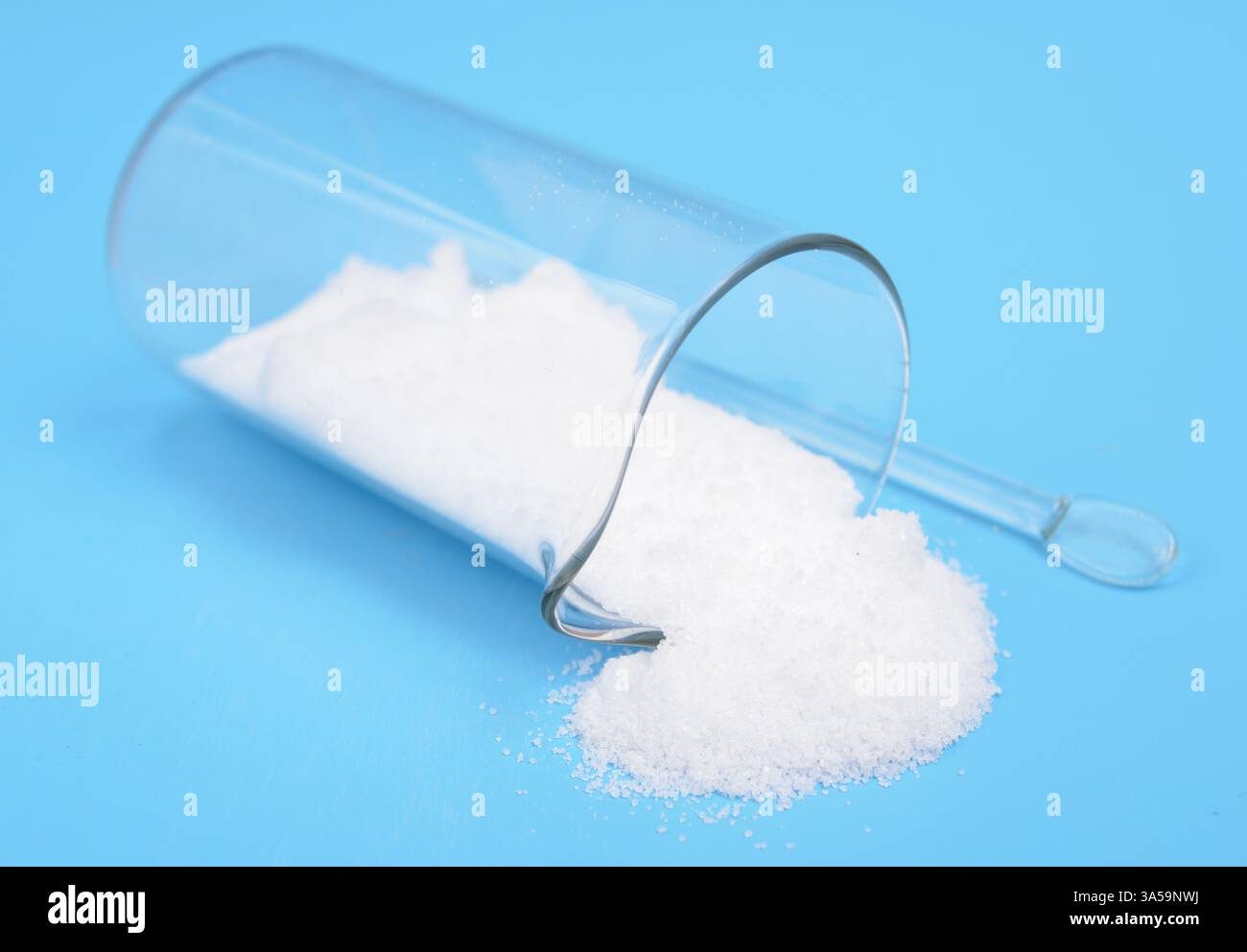 Thiourea powder on blue background Stock Photo