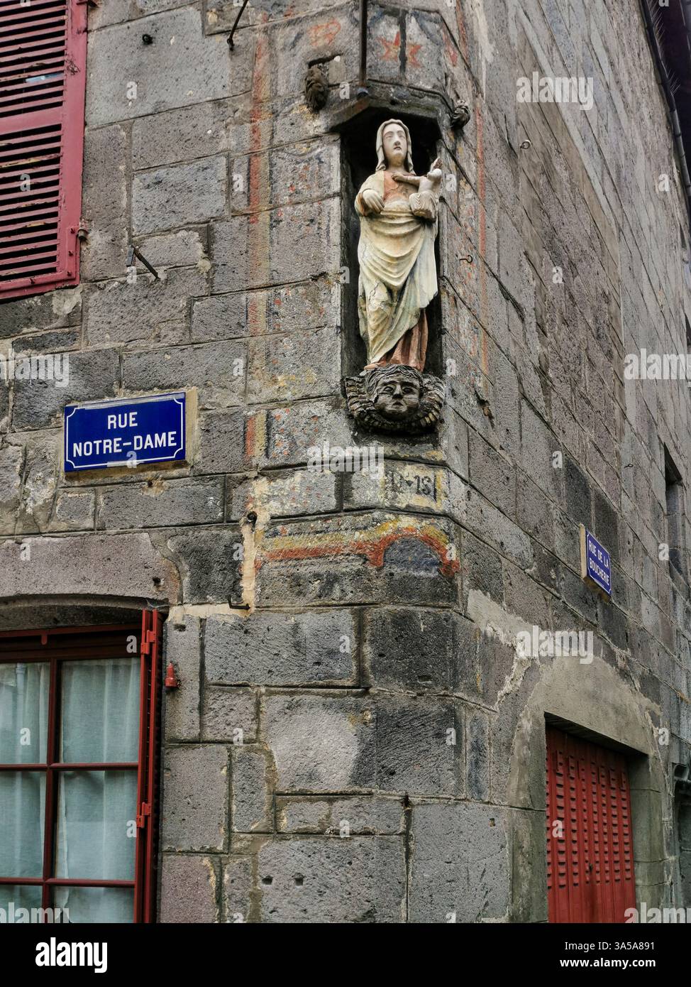 Religious stone carved statue of the Virgin Mary, medieval city of Besse et Saint Anastaise village, Puy de Dome department, Auvergne, France - Smartphone Captured Stock Image