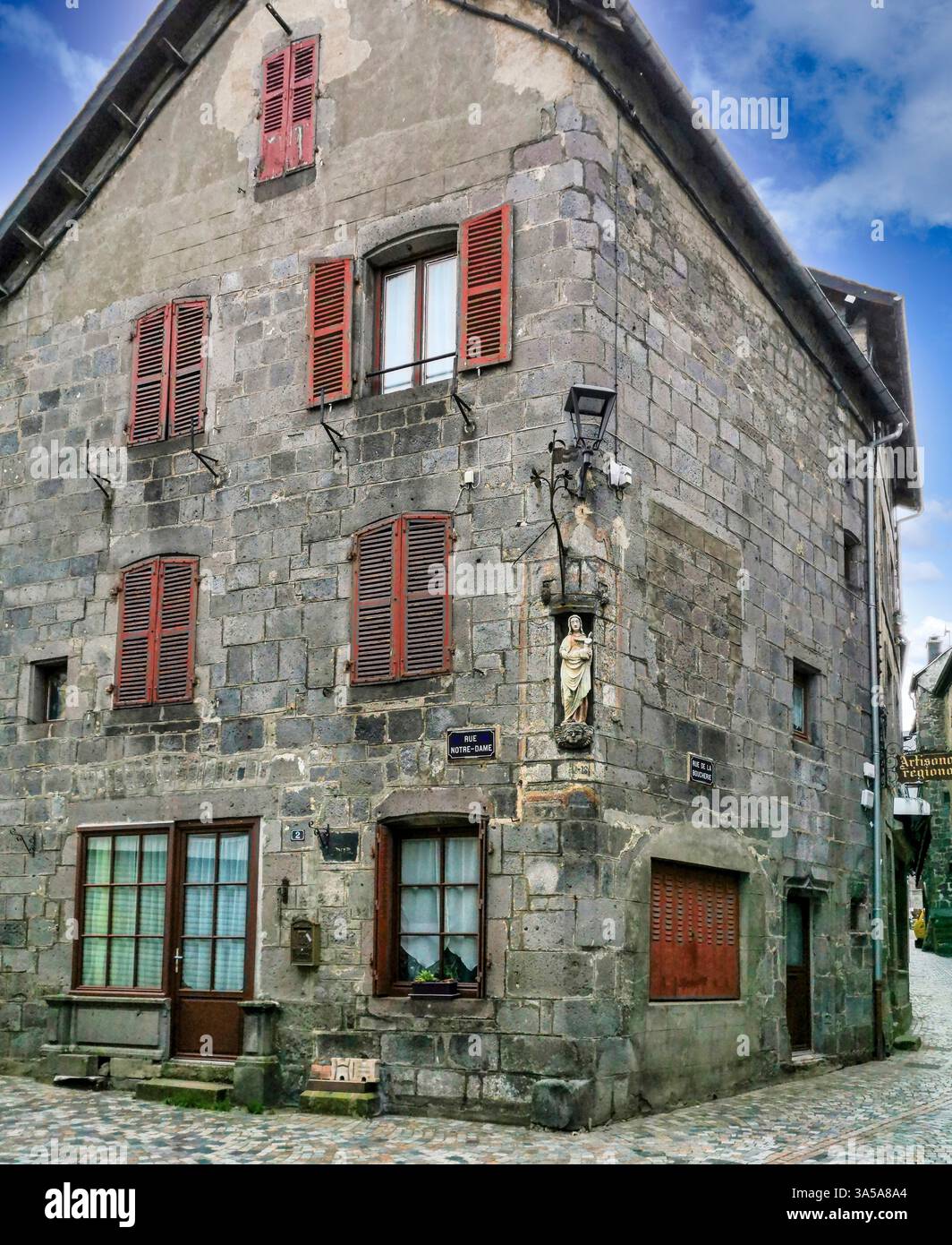 Religious stone carved statue of the Virgin Mary, medieval city of Besse et Saint Anastaise village, Puy de Dome department, Auvergne, France - Smartphone Captured Stock Image