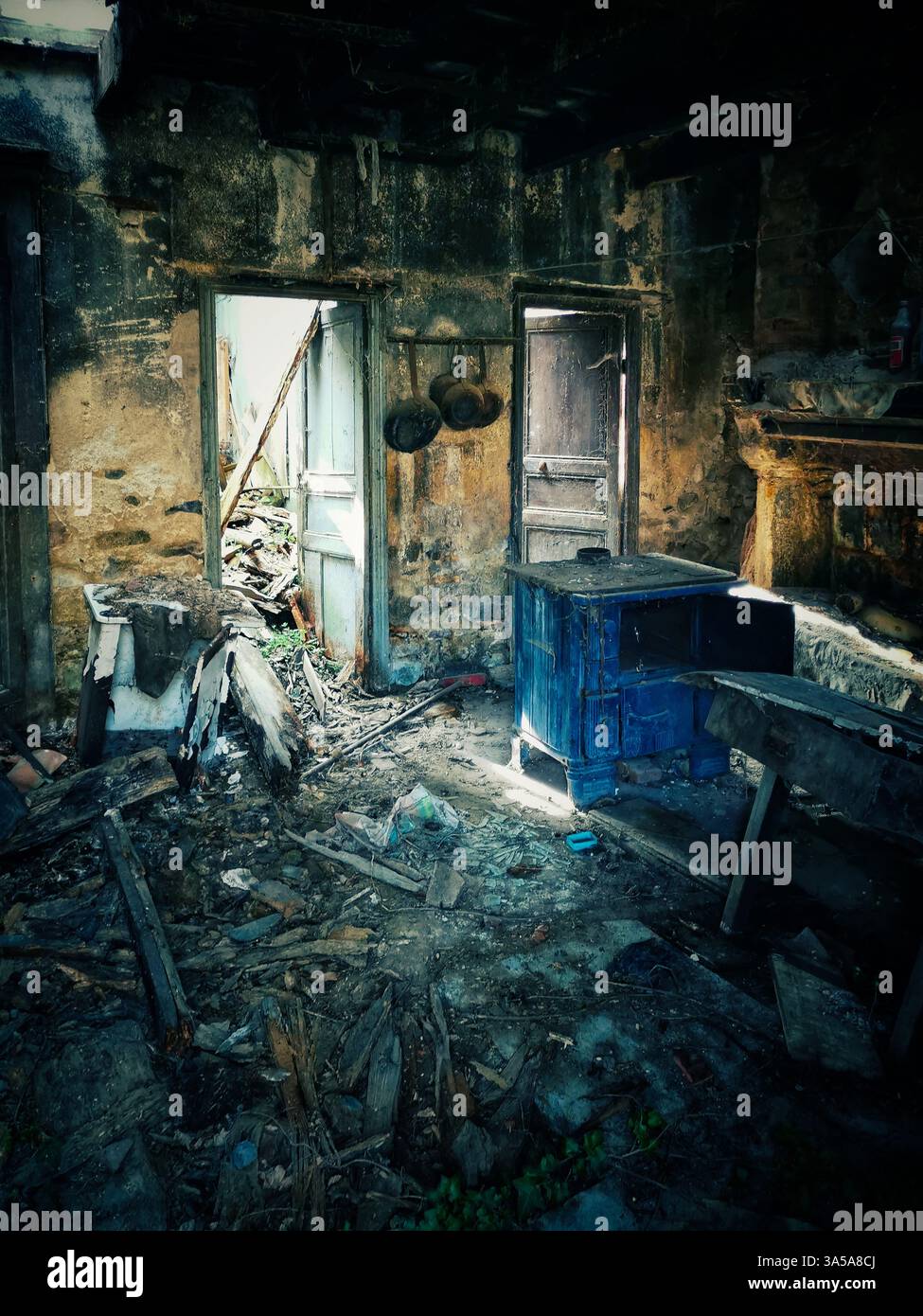 Abandoned interior with decaying furniture and dim light coming through door - Smartphone Captured Stock Image