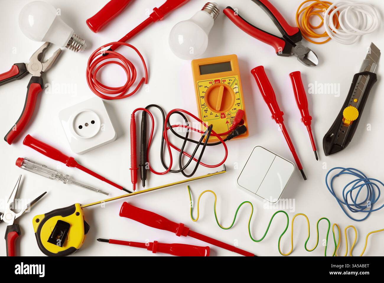 Different electrical tools on light background, flat lay Stock Photo