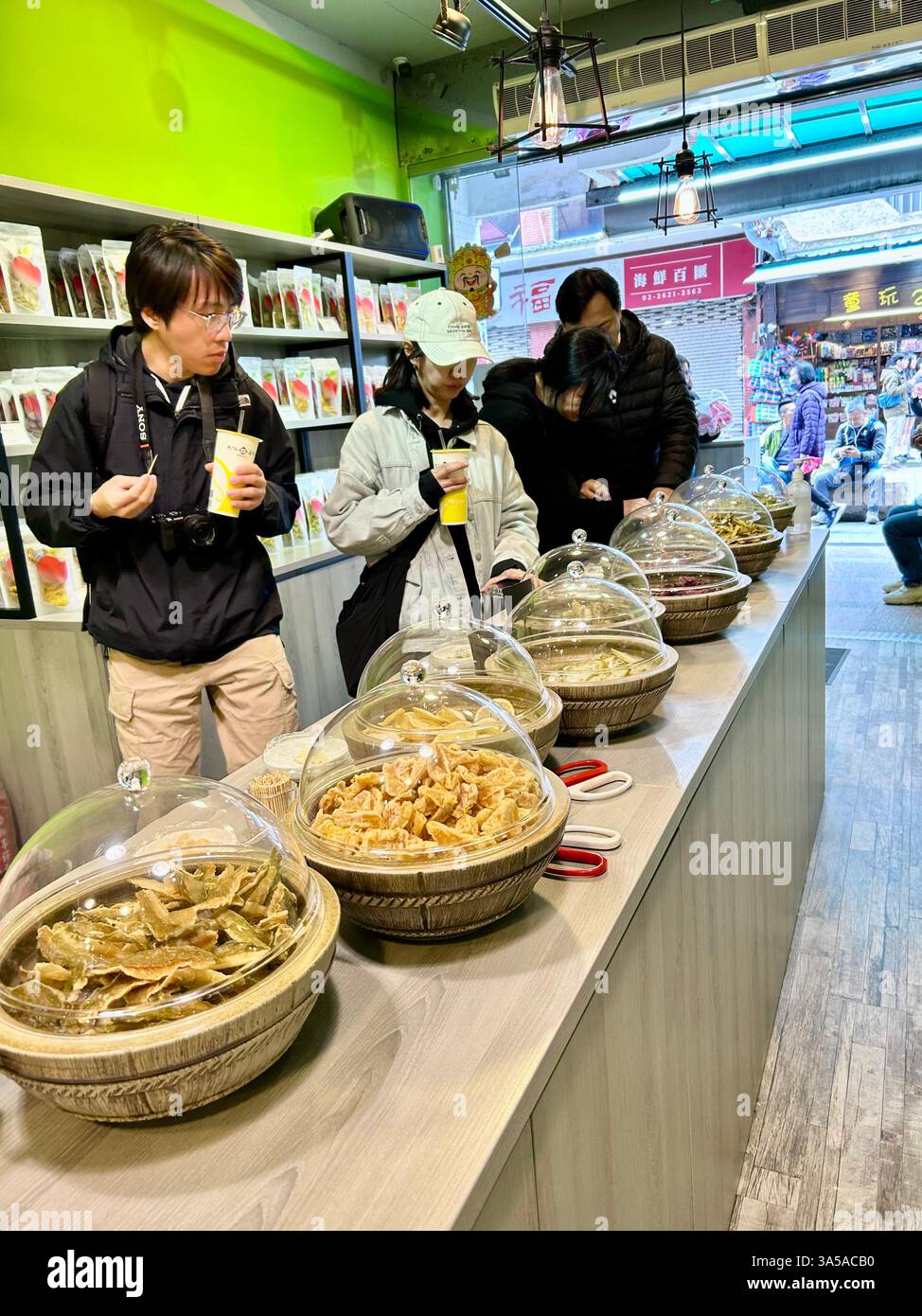 New Taipei, Taiwan, Group People, Woman, Tourists Shopping, Local Products, Visiting Old Street Stores, Tamsui District, Trying Food Samples - Smartphone Captured Stock Image