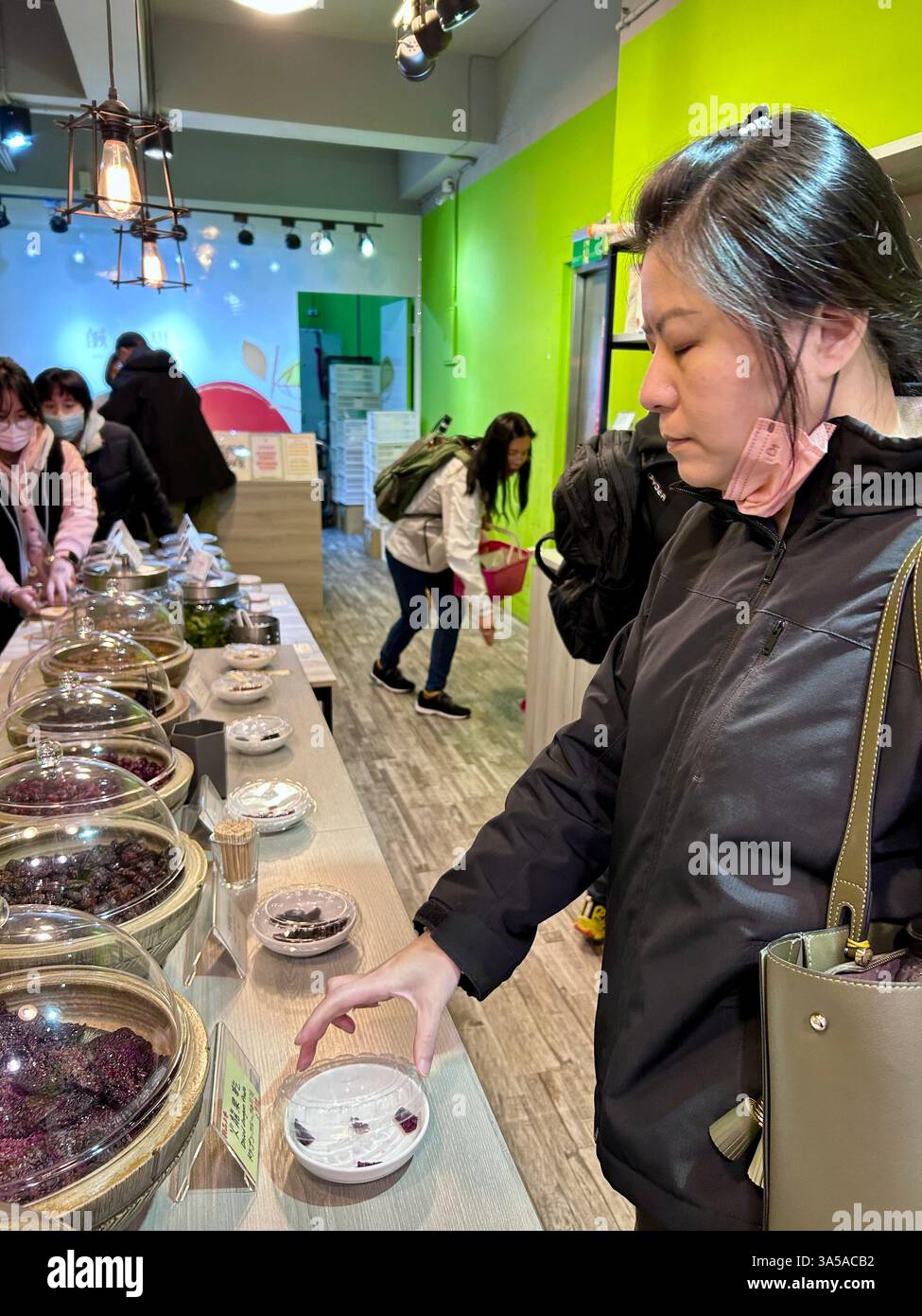 New Taipei, Taiwan, People, Woman, Tourists Shopping, Local Products, Visiting Old Street Stores, Tamsui District, Trying Food Samples - Smartphone Captured Stock Image