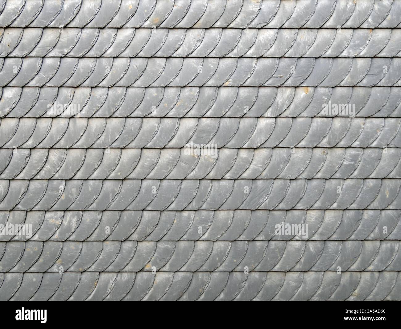 Gray slate shingles form a pattern on a facade, backgrounds Stock Photo