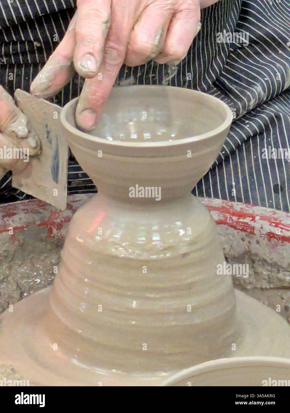Close up of hands working on potter's wheel Stock Photo