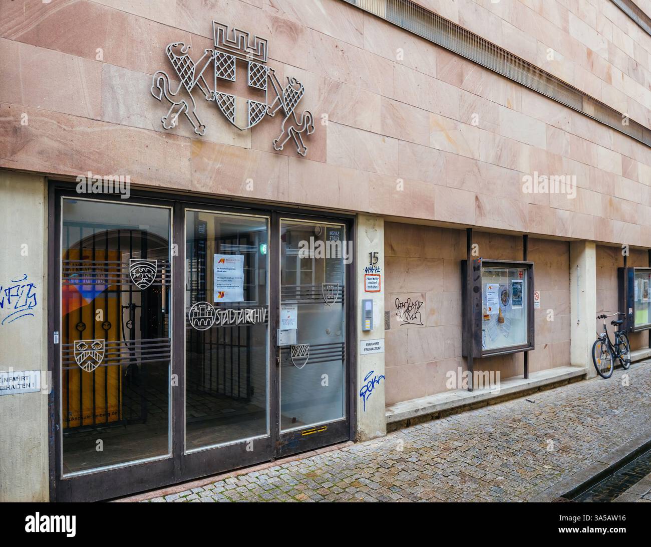 Freiburg, Germany - Feb 10, 2025: Exterior view of Freiburg Stadtarchiv building with emblem above the entrance doors, glass panels, notice board, gra Stock Photo