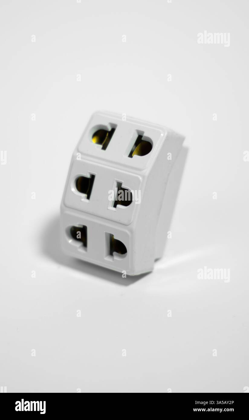 Universal Travel Adapter Electrical three Plug Converter Power Socket On White Background Stock Photo