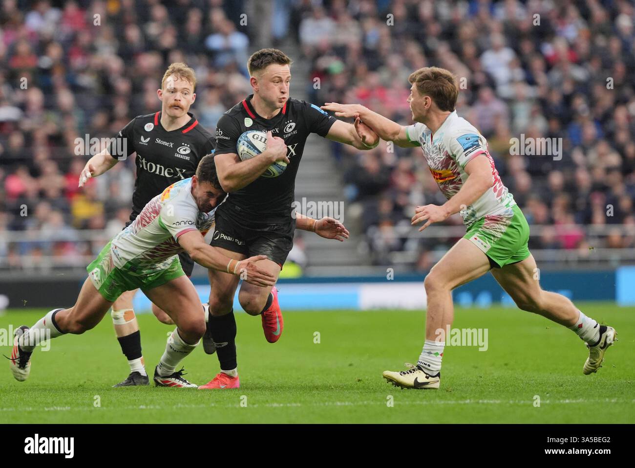 Saracens’ Fergus Burke (centre) is tackled by Harlequins’ Nick David ...