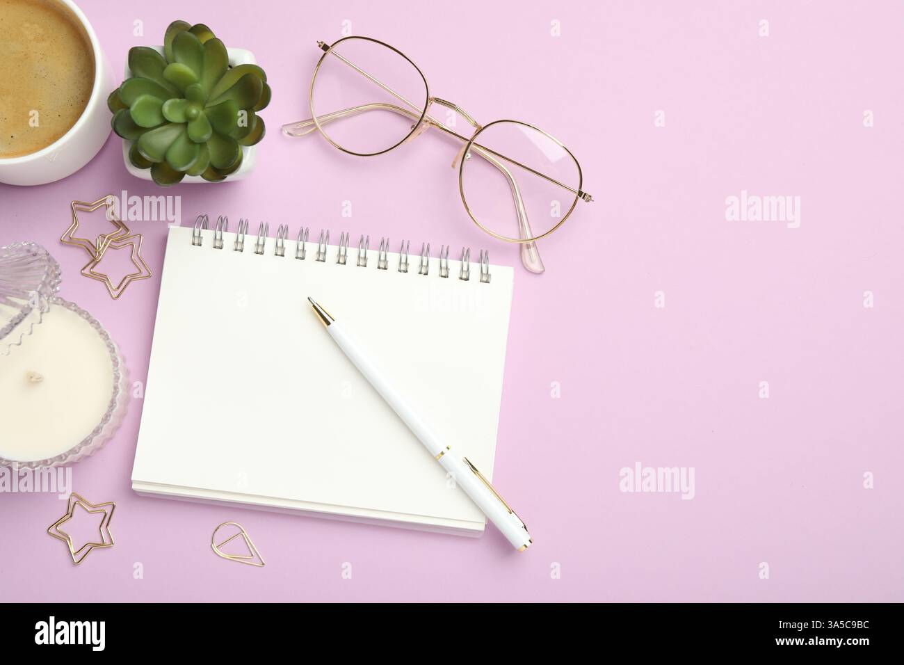 Paper clips, other different stationery, glasses, coffee and decor on lilac background, flat lay. Space for text Stock Photo