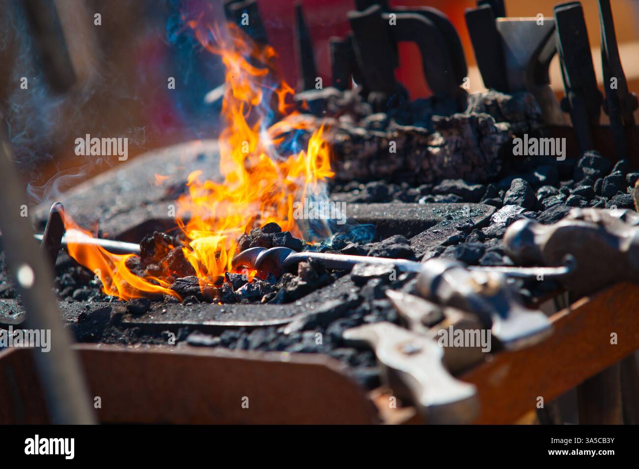 blacksmith forge with flames and tools Stock Photo - Alamy