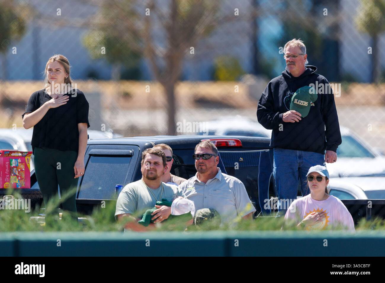 UAB fans salute the flag before an NCAA softball game between UAB and ...