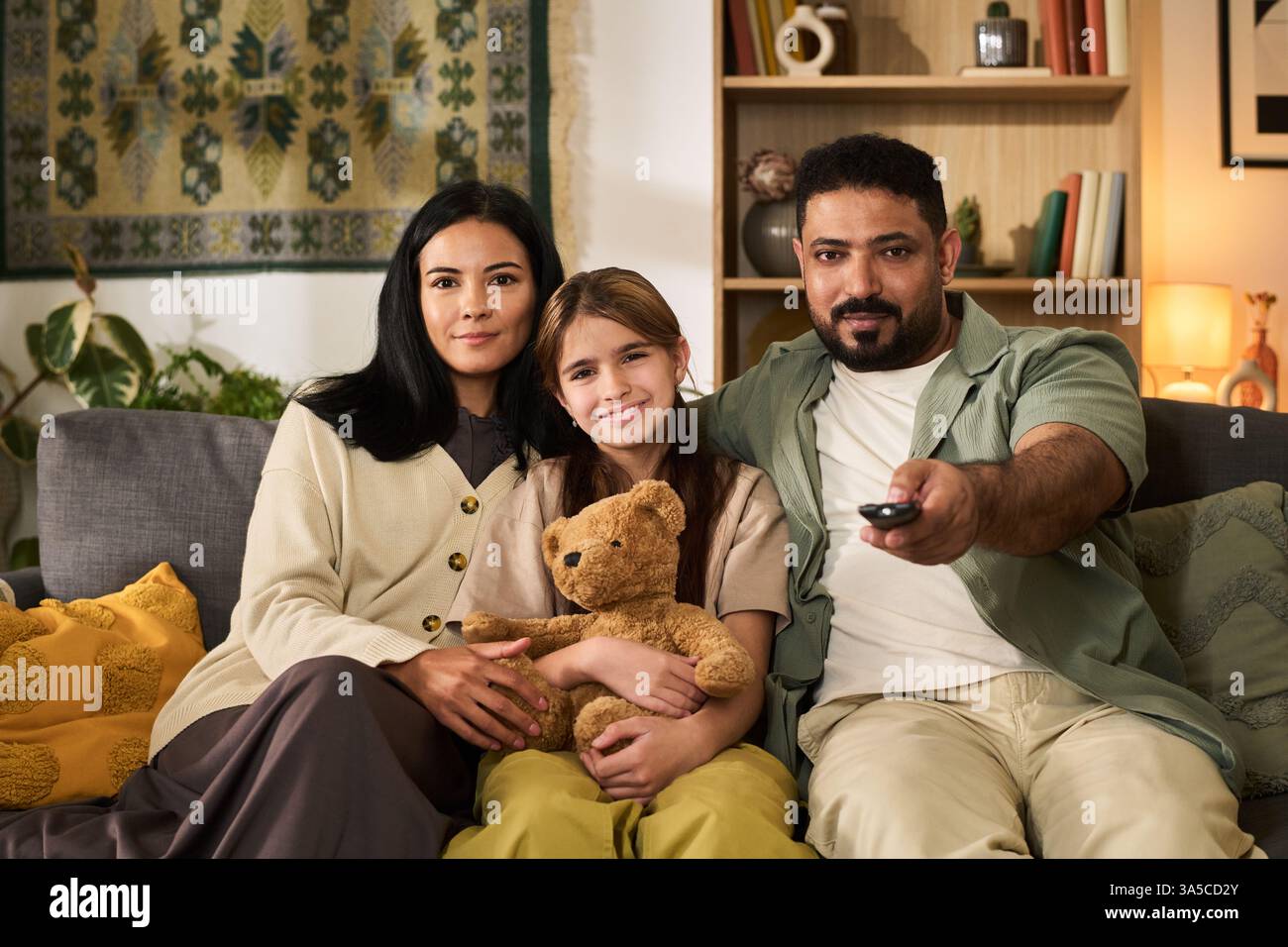 Multiracial family enjoying cozy time together on comfortable living