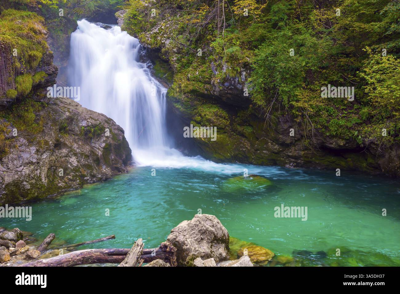 Mountain river with azure water. On the slopes of the gorge laid wooden ...