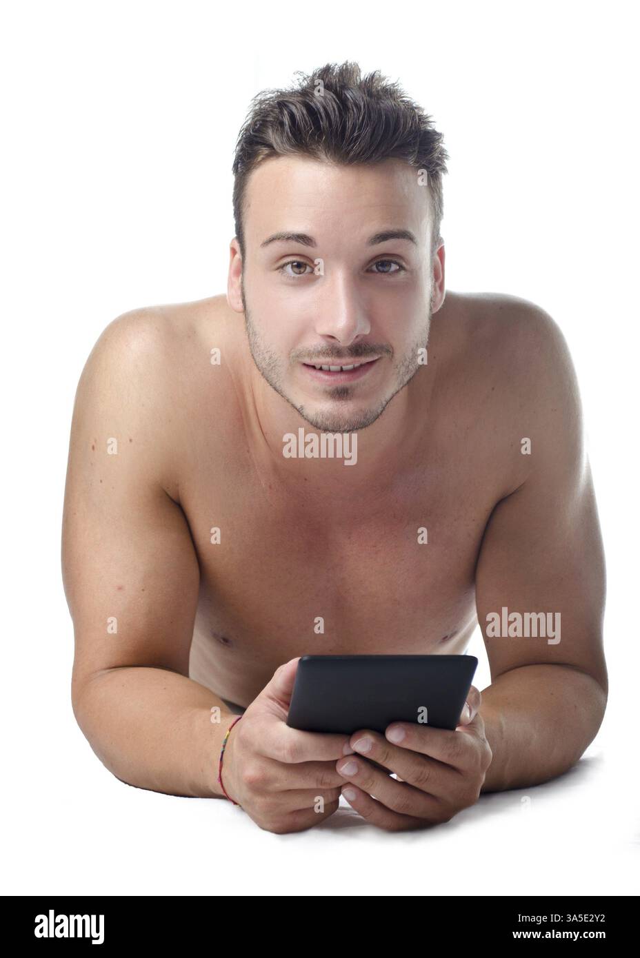 Attractive, fit young man holding ebook reader or tablet, smiling to camera Stock Photo
