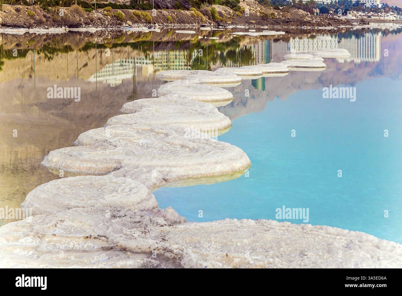 Winter dawn at the resorts of the Dead Sea. Picturesque white paths ...
