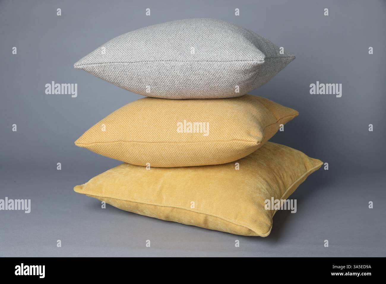 Stack of decorative pillows on grey background Stock Photo