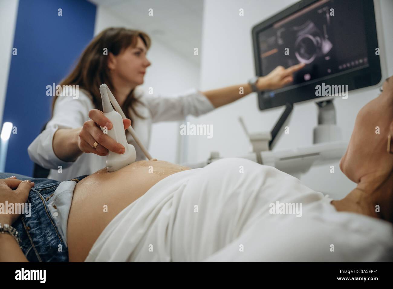 With big belly. Pregnant woman undergoing ultrasound test Stock Photo ...