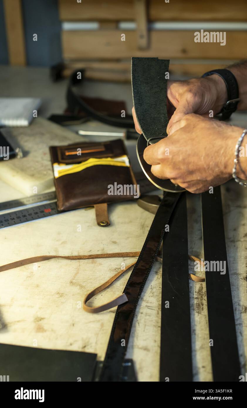 Tailor process leather in workshop. Making leather products Stock Photo