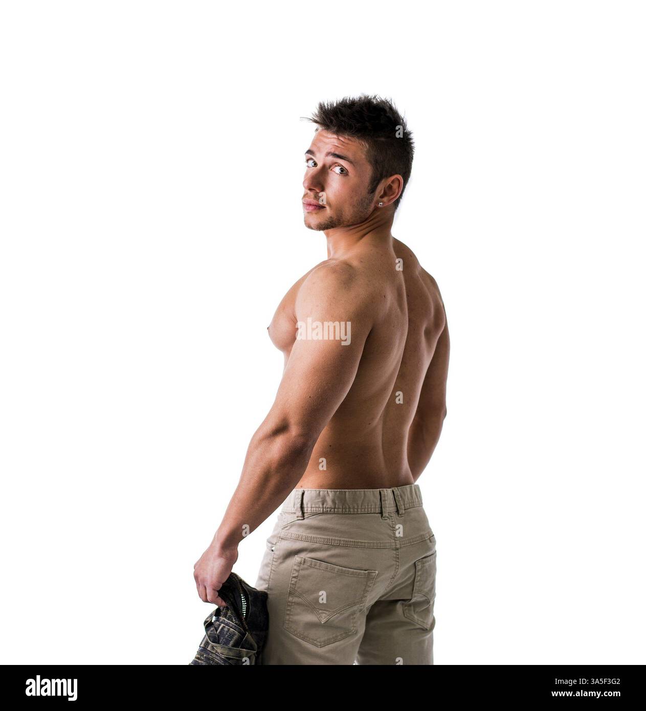 Turning Ripped Cute muscular ripped young bodybuilder turning to look at camera ...