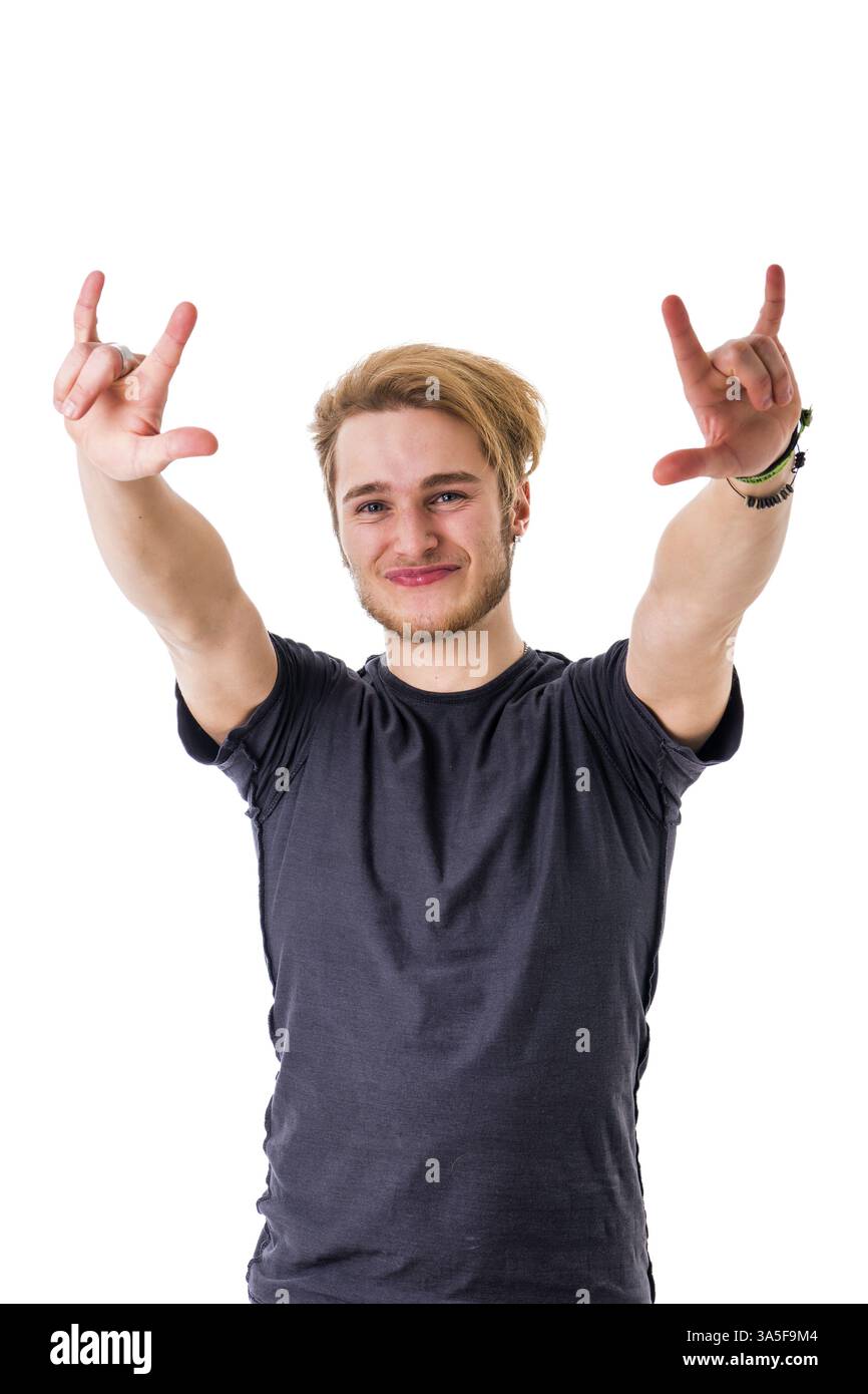 Smiling bearded young man with hands up showing horns with hands Stock Photo