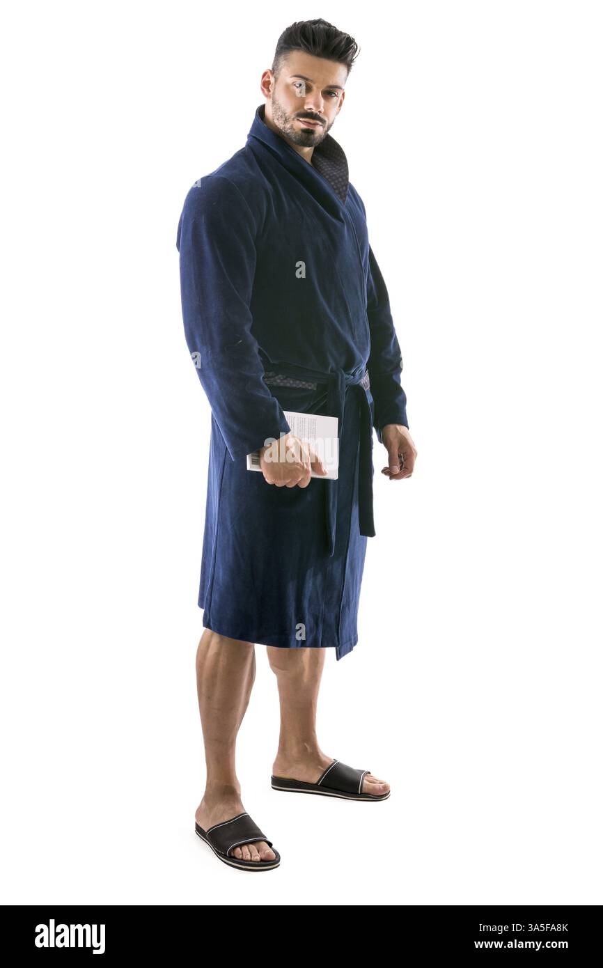 Handsome muscular male in bathrobe or nightrobe holding a book, isolated on white background Stock Photo