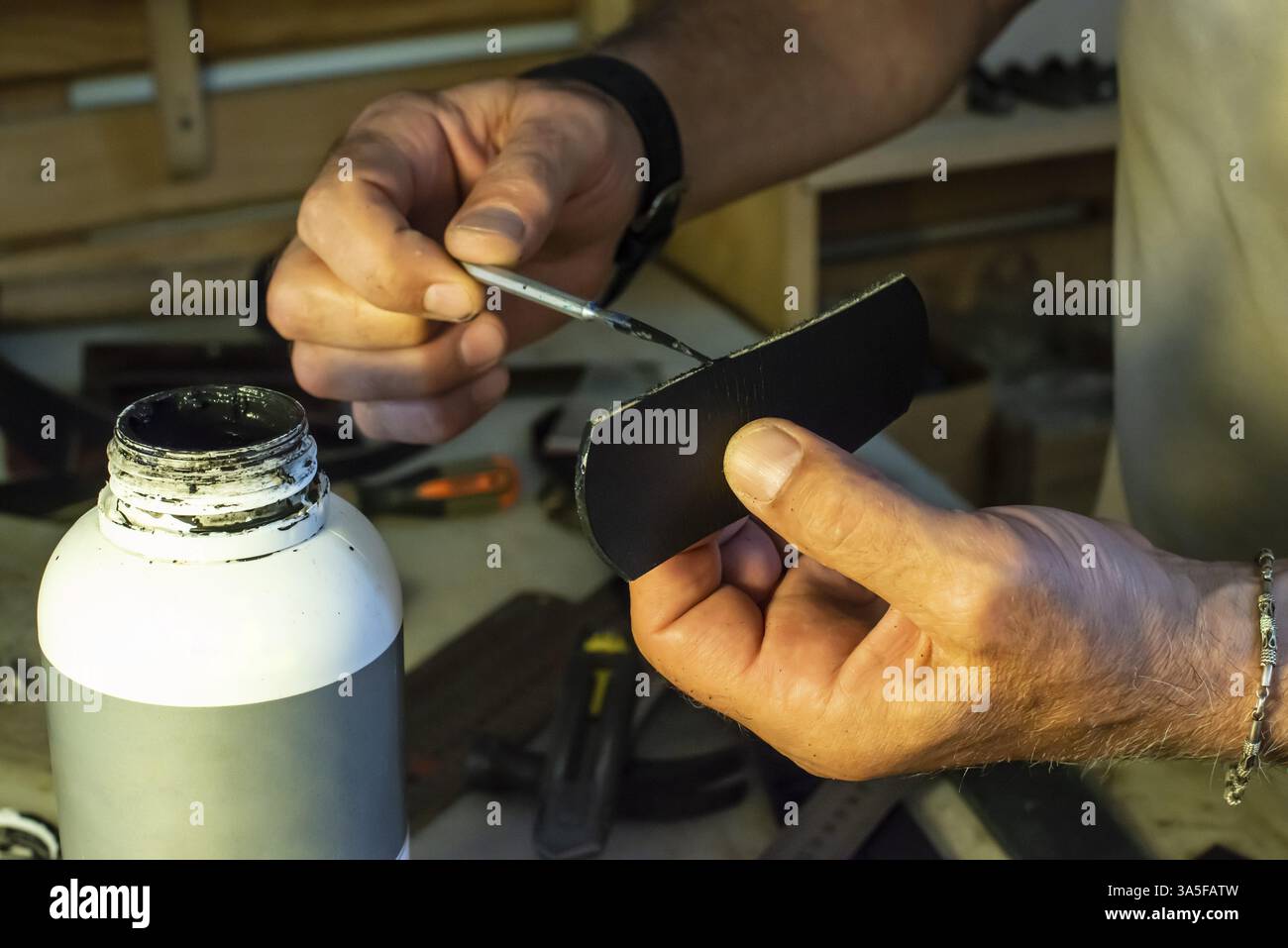 Tailor process leather in workshop. Making leather products Stock Photo