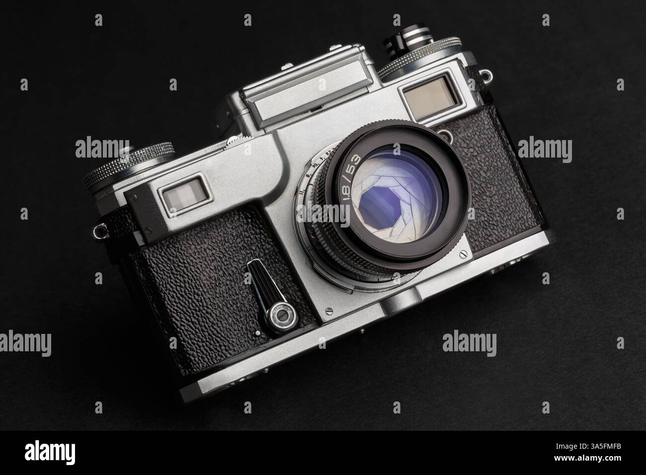 Old rangefinder camera with lens on dark background close-up Stock Photo
