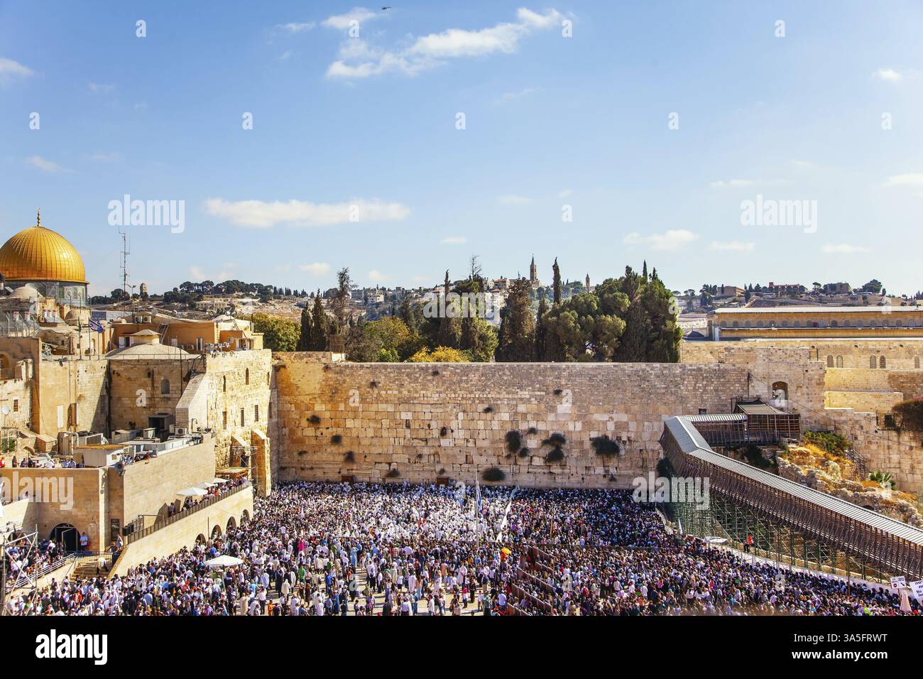 Huge crowd of praying Jews in the square in front of the Western Wall