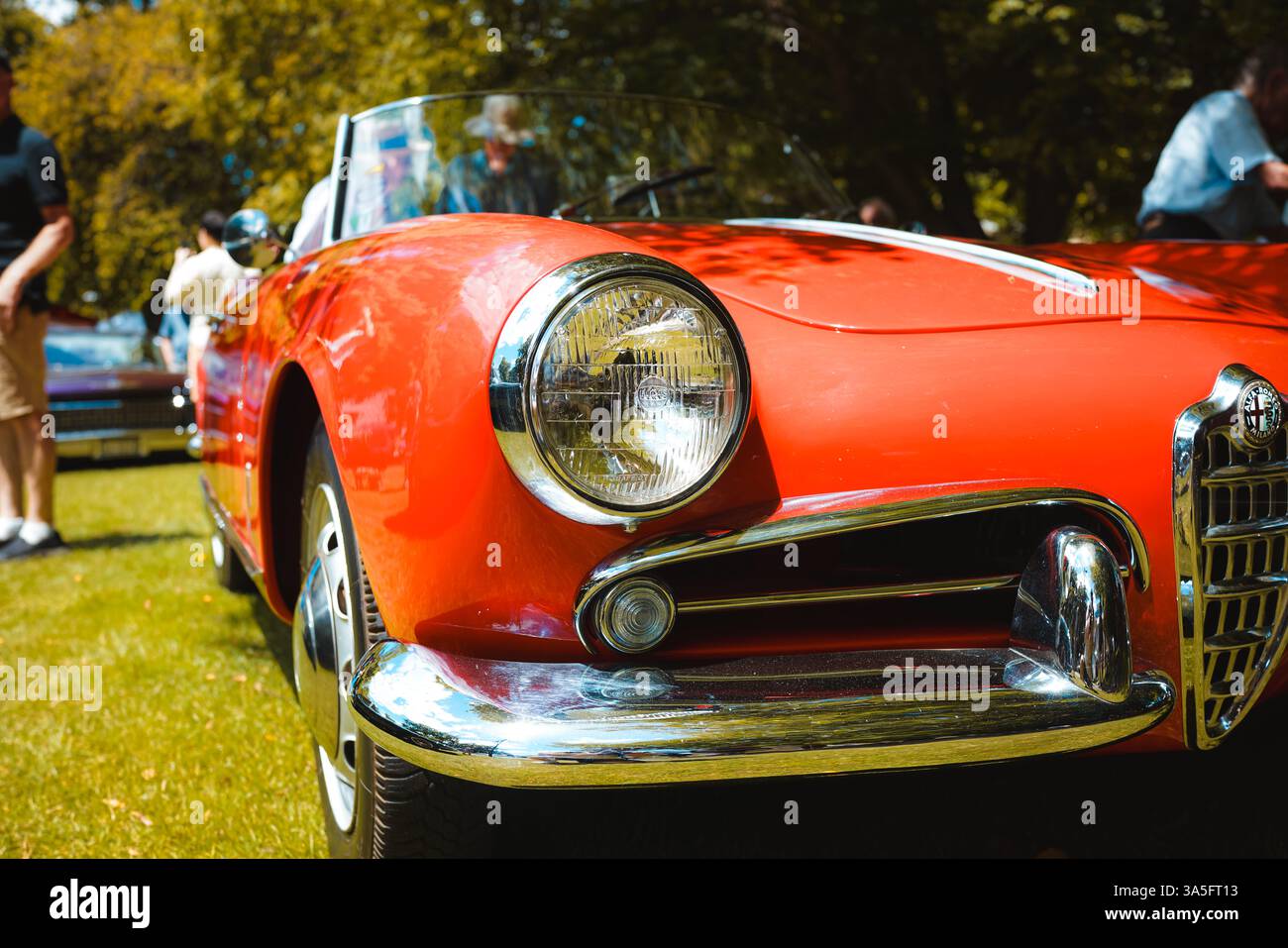 Day of the Dead meets joyful revelry: vintage cars, live music, and dancing souls under sunlit skies and papel picado hues. ? Stock Photo