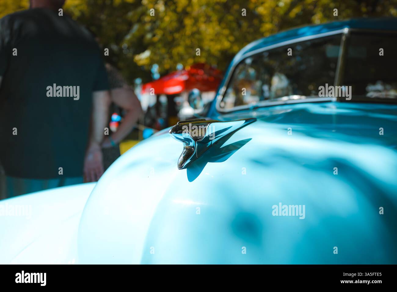 Day of the Dead meets joyful revelry: vintage cars, live music, and dancing souls under sunlit skies and papel picado hues. ? Stock Photo