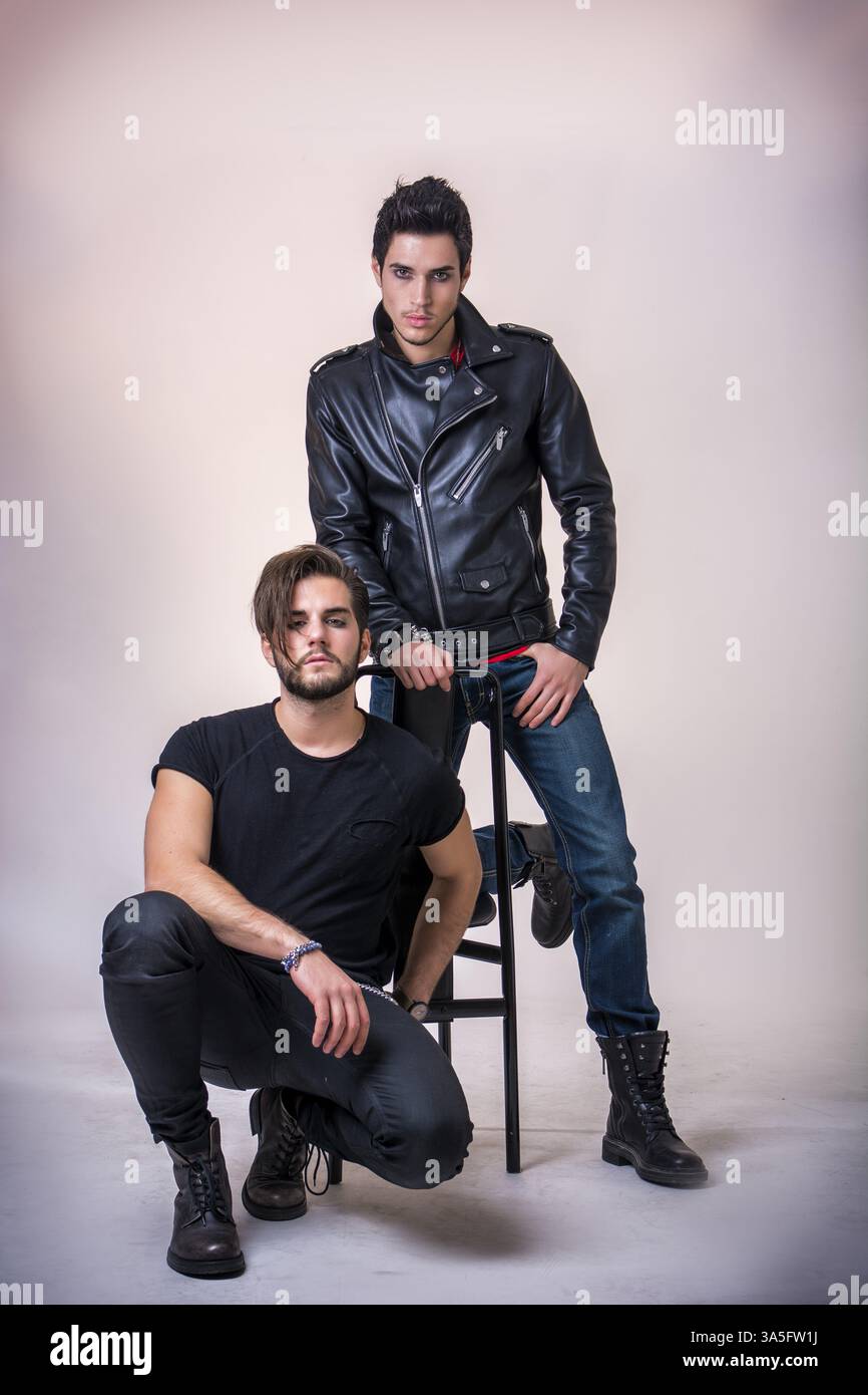 Two attractive young hard rock men posing in studio. White background Stock Photo