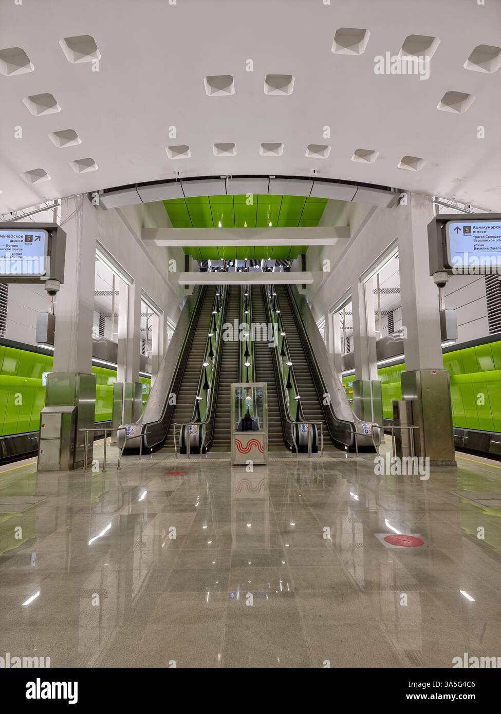 Interior of subway station Novomoskovskaya on the Troitskaya line (Троицкая) of the Moscow metro, with bright green colour; escalators - Smartphone Captured Stock Image