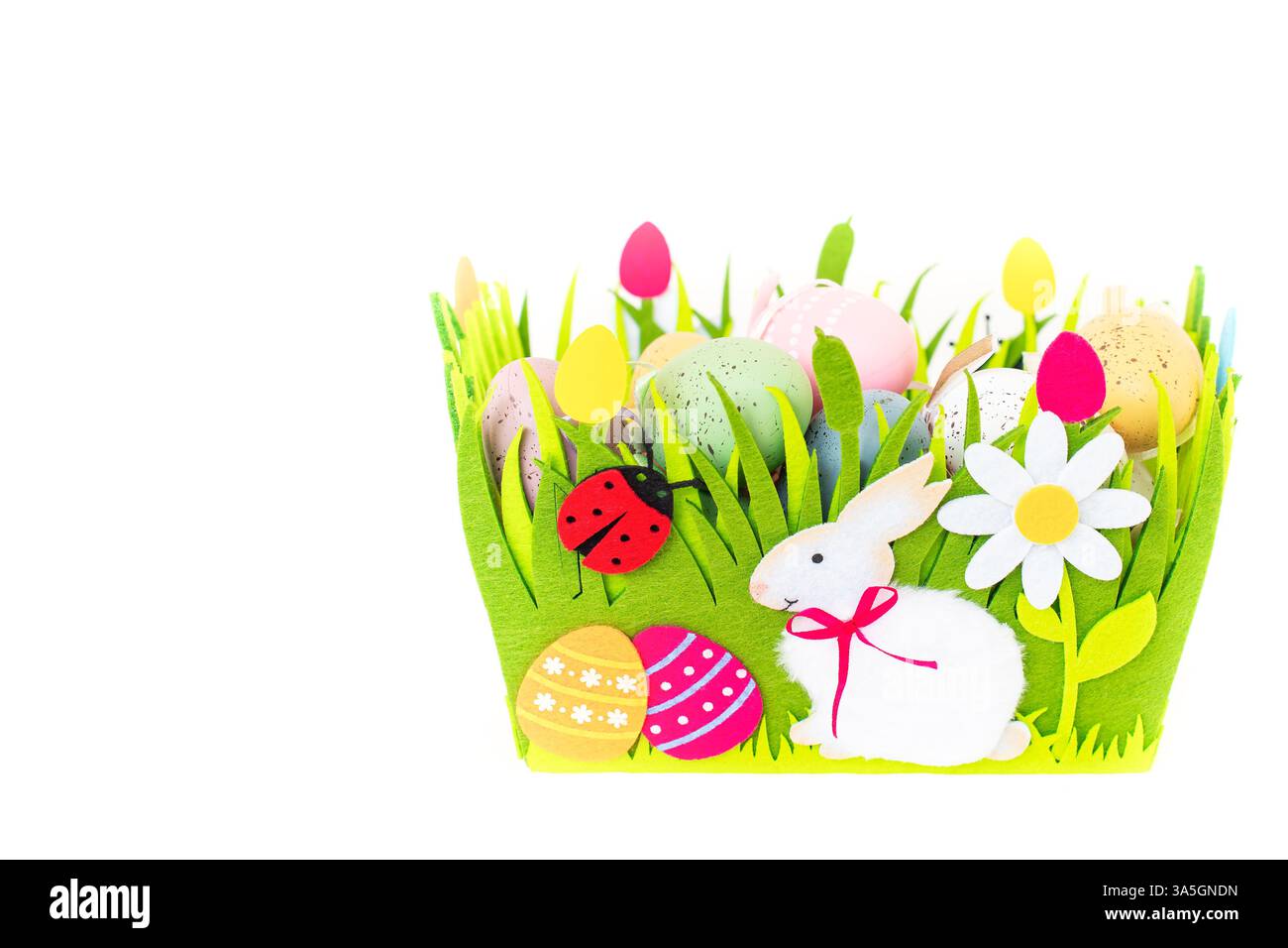 Green basket with multicolored Easter eggs isolated on white background with copy space Stock Photo