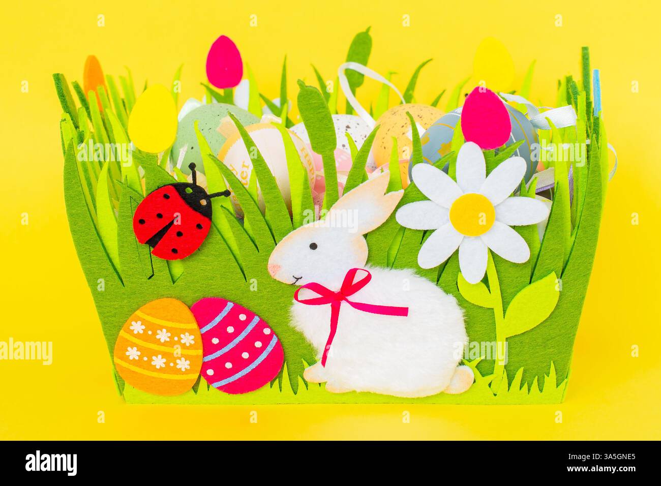 Easter eggs held in a decorative felt basket Stock Photo
